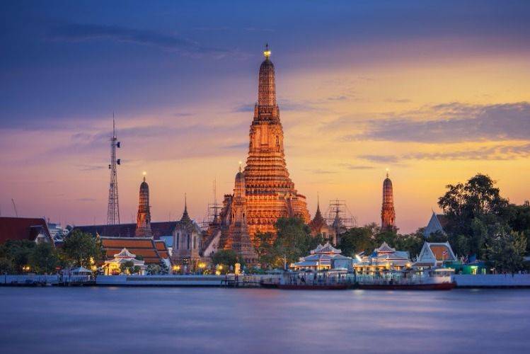 A young night along Chao Phraya river with a long tailed boat